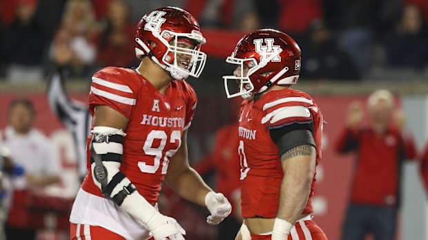 Nov 19, 2021; Houston, Texas, USA; Houston Cougars defensive lineman Logan Hall (92) celebrates defensive lineman Derek Parish (0) sack against Memphis Tigers quarterback Seth Henigan (14) (not pictured) in the fourth quarter at TDECU Stadium. Houston Cougars won 31 to 13. Mandatory Credit: Thomas Shea-USA TODAY Sports